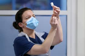 A nurse preparing a Covid-19 vaccine dose. Photo by Russell Cheyne - WPA Pool/Getty Images