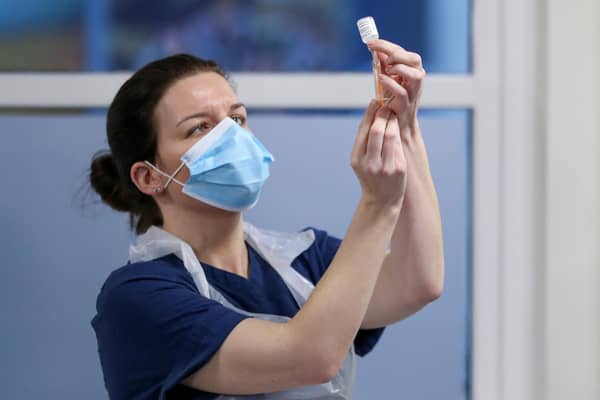 A nurse preparing a Covid-19 vaccine dose. Photo by Russell Cheyne - WPA Pool/Getty Images