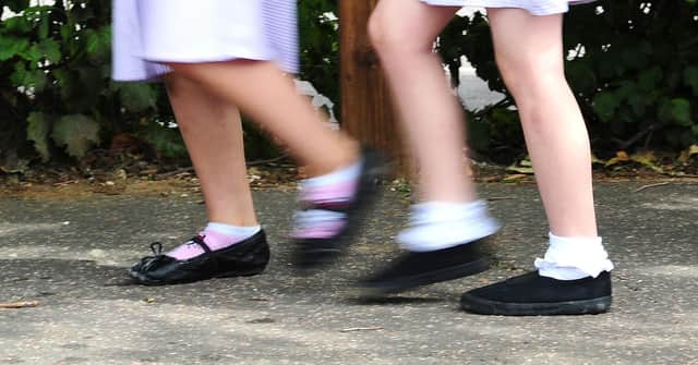File photo dated 15/07/14 of school girls walking to school. Nearly a third (31%) of parents and carers do not talk to their children openly about money, according to research for a UK Government-backed body. The findings were released by MoneyHelper to mark Talk Money Week (November 8 to 12). Issue date: Monday November 8, 2021.