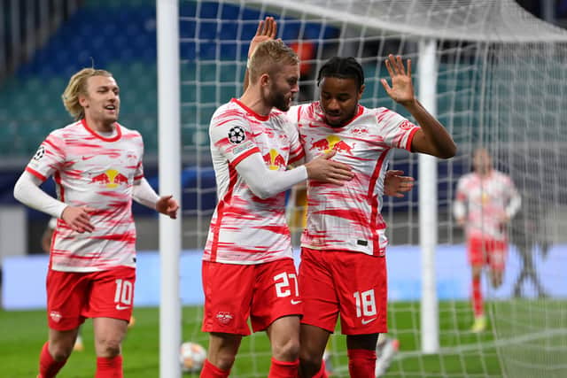 LEIPZIG, GERMANY - NOVEMBER 03: Christopher Nkunku of RB Leipzig celebrates with teammates Konrad Laimer and Emil Forsberg after scoring their team's first goal during the UEFA Champions League group A match between RB Leipzig and Paris Saint-Germain at Red Bull Arena on November 03, 2021 in Leipzig, Germany. (Photo by Stuart Franklin/Getty Images)