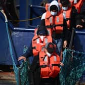 A group of migrants disembark from a UK Border Force boat at the port of Dover having being picked up crossing the English Channel from France. Credit: Getty 