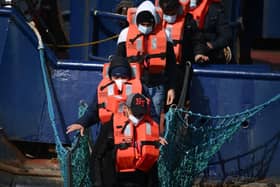 A group of migrants disembark from a UK Border Force boat at the port of Dover having being picked up crossing the English Channel from France. Credit: Getty 