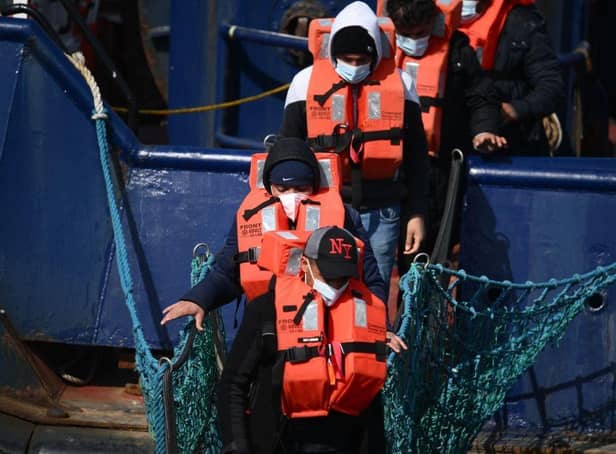 <p>A group of migrants disembark from a UK Border Force boat at the port of Dover having being picked up crossing the English Channel from France. Credit: Getty </p>