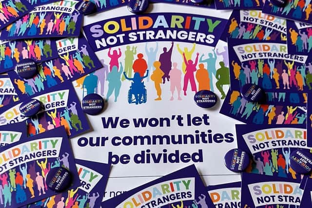 'Solidarity not strangers' badges, posters and postcards have been shared across Greater Manchester