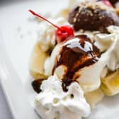 Banana split ice cream served on white plate Picture: Adobe
