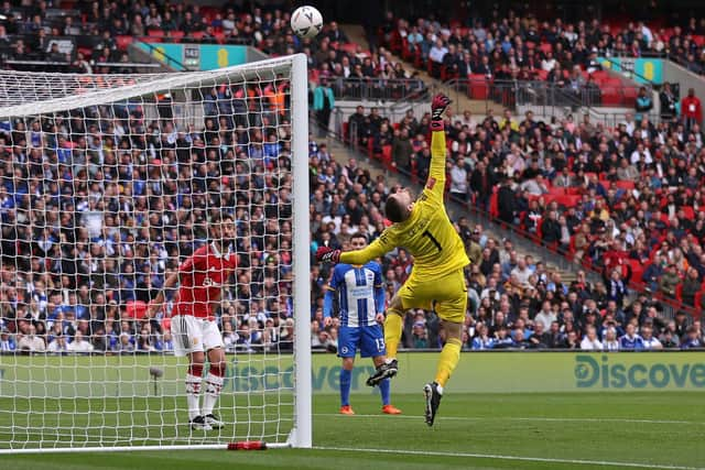 Manchester United's Spanish goalkeeper David de Gea makes a save during the English FA Cup semi-final football match between Manchester United and Brighton and Hove Albion at Wembley Stadium in north west London on April 23, 2023. (Photo by ADRIAN DENNIS / AFP) / (Photo by ADRIAN DENNIS/AFP via Getty Images)