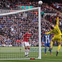Manchester United's Spanish goalkeeper David de Gea makes a save during the English FA Cup semi-final football match between Manchester United and Brighton and Hove Albion at Wembley Stadium in north west London on April 23, 2023. (Photo by ADRIAN DENNIS / AFP) / (Photo by ADRIAN DENNIS/AFP via Getty Images)