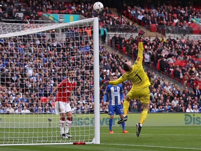Manchester United's Spanish goalkeeper David de Gea makes a save during the English FA Cup semi-final football match between Manchester United and Brighton and Hove Albion at Wembley Stadium in north west London on April 23, 2023. (Photo by ADRIAN DENNIS / AFP) / (Photo by ADRIAN DENNIS/AFP via Getty Images)