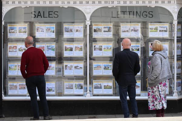 People looking at house price signs displayed in the window of an estate agents in Lewes, East Sussex, as the Office for National Statistics (ONS) has said that the average UK house price has surged by £24,000 during the past year of coronavirus lockdowns. Issue date: Wednesday May 19, 2021.