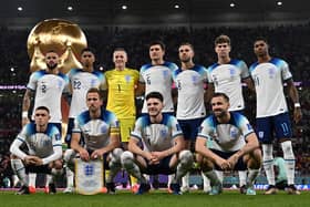 England players pose for a squad photo ahead of their Group B clash with Wales - with a 3-0 victory in the game setting up a last-16 tie with Senegal. (Photo by PAUL ELLIS/AFP via Getty Images)