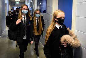 Pupils wearing face coverings in a school corridor (Photo by ANDY BUCHANAN/Digital/AFP via Getty Images)