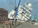 A ship is currently leaning towards the docks at a worrying angle in Leith, Edinburgh. (Photo credit: @Tomafc83 on Twitter)