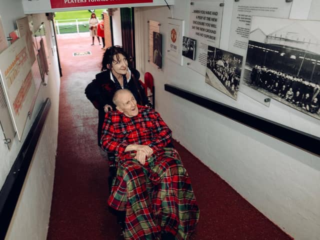 Tommy Heron going through the old player's tunnel with Brookdale View Home Manager Karen Wolstenholme