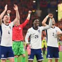 Declan Rice, Kobbie Mainoo and Luke Shaw celebrate after England beat the Netherlands during the UEFA EURO 2024 semi-final match.