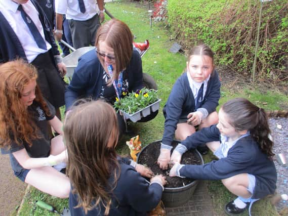 Pupils from St Mary’s Primary School enhancing Rose Court's garden area