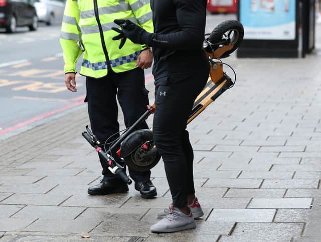 An e-scooter rider is stopped by a police officer in Islington, London, during an operation to educate them as to the risks associated with the use of e-scooters, which are currently illegal to use on the public highways including pavements.