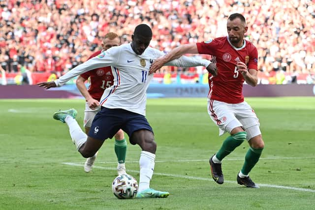 BUDAPEST, HUNGARY - JUNE 19: Ousmane Dembele of France looks to cross the ball whilst under pressure from Attila Fiola of Hungary during the UEFA Euro 2020 Championship Group F match between Hungary and France at Puskas Arena on June 19, 2021 in Budapest, Hungary. (Photo by Tibor Illyes - Pool/Getty Images)