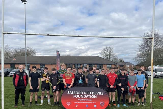 Salford Red Devils player Charlie Glover (first left) at a coaching session for the club's foundation.