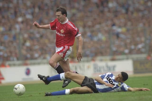 Sheffield Wednesday's Paul Williams slides in on Manchester United's Bryan Robson during the 1991 Rumbelows Cup final.