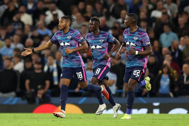 MANCHESTER, ENGLAND - SEPTEMBER 15: Christopher Nkunku of RB Leipzig celebrates with teammates after scoring their side's third goal and his hat-trick during the UEFA Champions League group A match between Manchester City and RB Leipzig at Etihad Stadium on September 15, 2021 in Manchester, England. (Photo by Richard Heathcote/Getty Images)