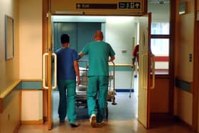 Orderlies push a bed at the Royal Orthopaedic Hospital, Oswestry.