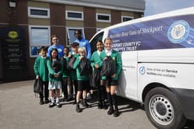Stockport County players Lewis Bate and Jay Mingi deliver PE kits to Cheadle Heath Primary School