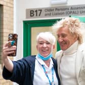 Sir Rod Stewart poses for photos with members of staff at the Princess Alexandra Hospital in Harlow, Essex