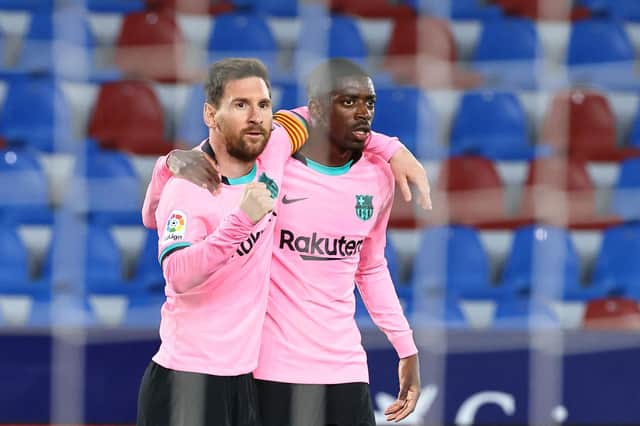 Barcelona's Argentinian forward Lionel Messi (L) celebrates with Barcelona's French forward Ousmane Dembele after scoring during the Spanish league football match Levante UD against FC Barcelona at the Ciutat de Valencia stadium in Valencia on May 11, 2021. (Photo by JOSE JORDAN / AFP) (Photo by JOSE JORDAN/AFP via Getty Images)