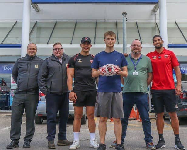 Salford Red Devils stars Tim Lafai and Nene MacDonald with representatives from the Salford branches