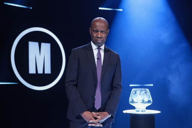 Host Clive Myrie with Mastermind trophy