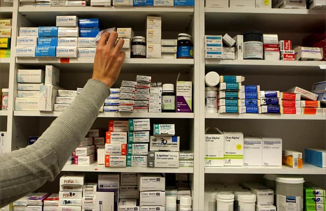 A pharmacist stocks shelves at a chemist in Dublin as Health Minister Mary Harney was urged to be cautious about adding a 50 cent fee on every drug prescribed to a medical card holder as part of a range of health service savings in the Budget.