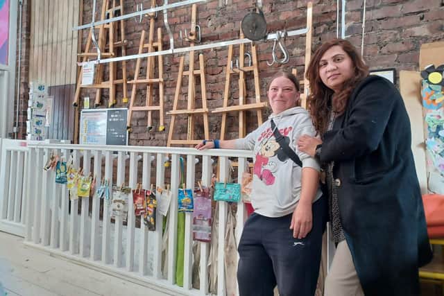 Helen Cassidy and Aisha Mahmood with the rubbish timeline