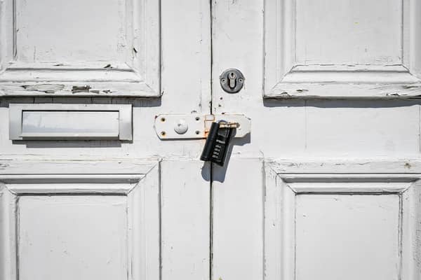 NOTE: IMAGE 12 OF A SET OF 35 IMAGES FEATURING LOCKED GATES OF BUSINESSES AND PLACES THAT ARE CLOSED DURING UK LOCKDOWN A black combination lock secures a hasp on a door to a puzzlair escape game centre in Bristol to prevent access as the UK continues in lockdown to help curb the spread of the coronavirus.