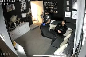 Officers watching television in Abbygail Lawton's home

