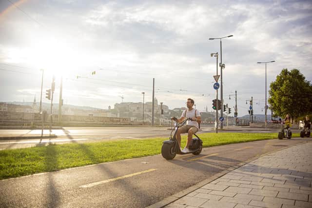 Speeding along during the e-scooter tour. Image: Eduardo Munoz Norambuena