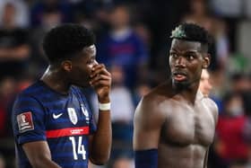 France's midfielder Paul Pogba (R) reacts as he speaks with France's midfielder Aurelien Tchouameni (L) at the end of the FIFA World Cup Qatar 2022 qualification Group D football match between France and Bosnia-Herzegovina, at the Meineau stadium in Strasbourg, eastern France, on September 1, 2021. (Photo by FRANCK FIFE / AFP) (Photo by FRANCK FIFE/AFP via Getty Images)