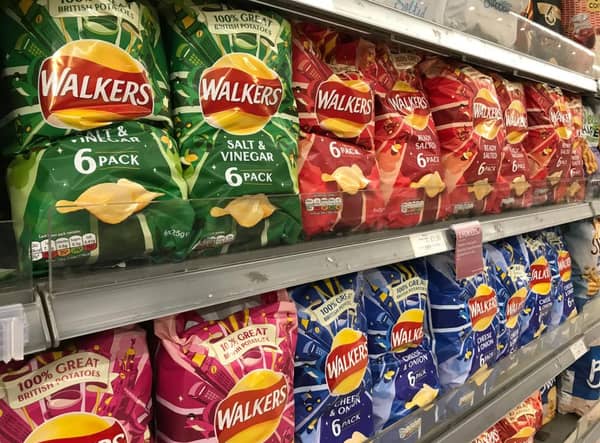 Packets of Walkers crisps on shelves in a supermarket (Shutterstock)