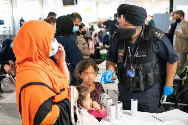 A Border Force worker processes refugees from Afghanistan last week. Northumberland is looking to welcome at least six families.