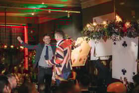 Kevin Walmsley wins £2,000 at AO's Christmas Party, with Founder and CEO, John Roberts