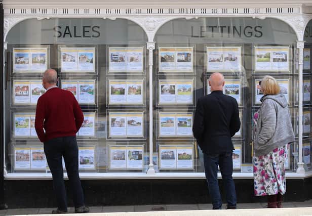 People looking at house price signs displayed in the window of an estate agents in Lewes, East Sussex, as the Office for National Statistics (ONS) has said that the average UK house price has surged by £24,000 during the past year of coronavirus lockdowns. Issue date: Wednesday May 19, 2021.
