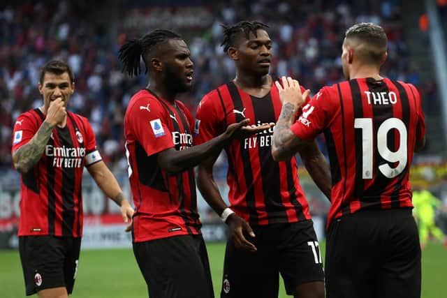 MILAN, ITALY - SEPTEMBER 12: Rafael Leao (C) of AC Milan celebrates with his team-mates Theo Hernandez (R) and Franck Kessie (L) after scoring the opening goal during the Serie A match between AC Milan and SS Lazio at Stadio Giuseppe Meazza on September 12, 2021 in Milan, Italy. (Photo by Marco Luzzani/Getty Images)
