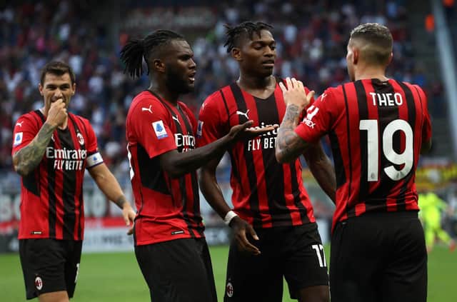 MILAN, ITALY - SEPTEMBER 12: Rafael Leao (C) of AC Milan celebrates with his team-mates Theo Hernandez (R) and Franck Kessie (L) after scoring the opening goal during the Serie A match between AC Milan and SS Lazio at Stadio Giuseppe Meazza on September 12, 2021 in Milan, Italy. (Photo by Marco Luzzani/Getty Images)