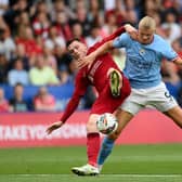 Erling Haaland will hope to fire Man City to title glory. Liverpool's Andy Robertson will have other ideas, however.