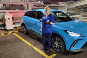Christie at Home nurse Sarah Richardson with one of the new electric MG4s