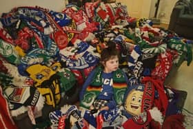 Alfie in his sea of scarves.
